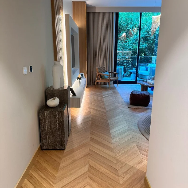 Herringbone wood floor in a bright living room