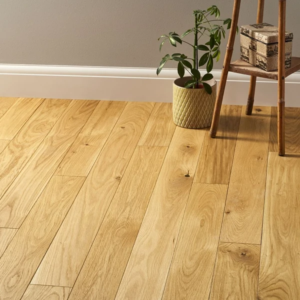 Natural light reflecting on light-colored oak wood flooring in a room.