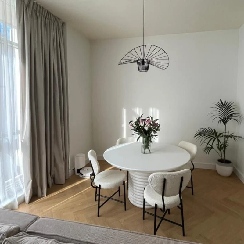 light-toned Herringbone wood floor in a bright, modern dining room.